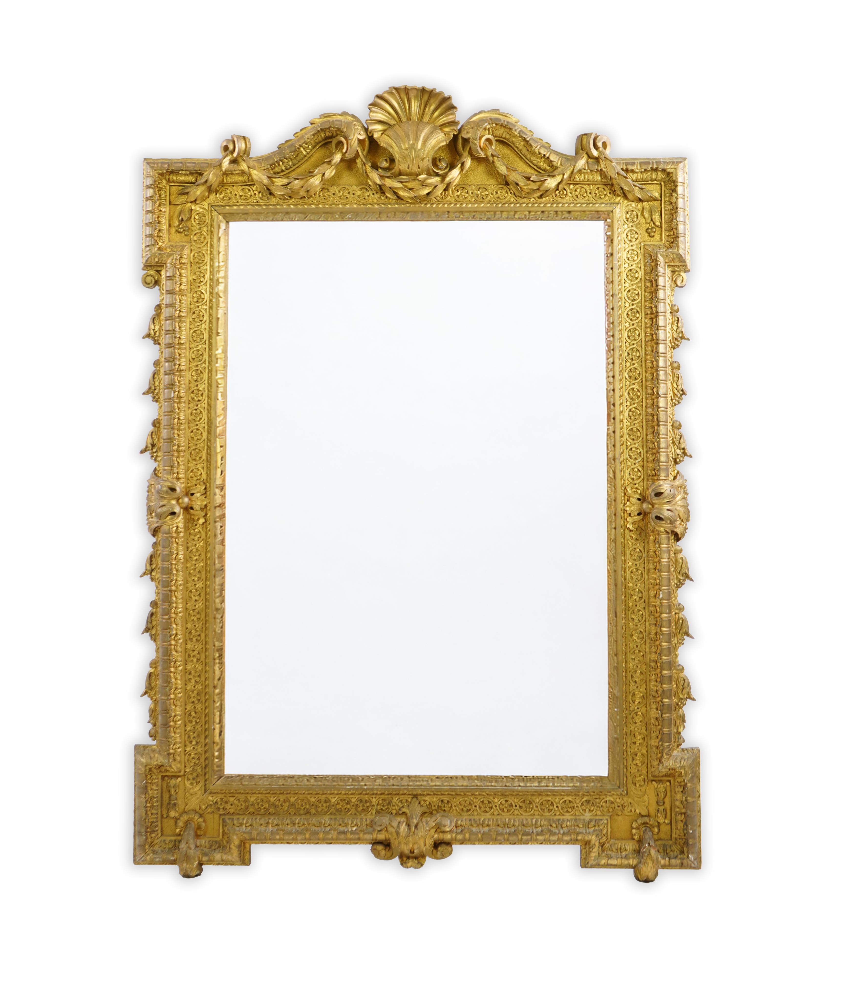 A late 19th century French carved gilt wood and composition overmantel mirror